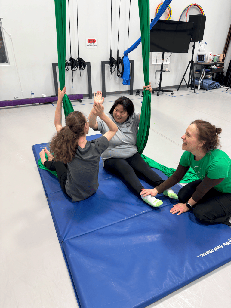 Participants and an instructor in an aerial silks class at Hunter Dance Center